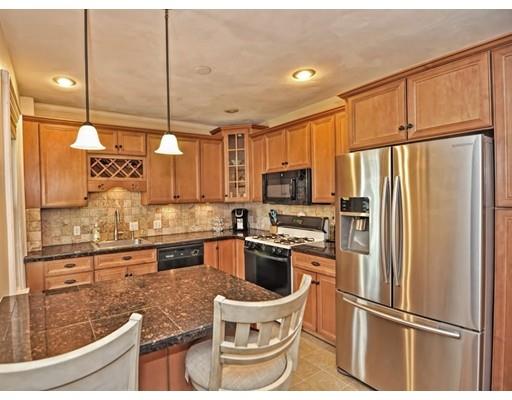 a kitchen with stainless steel appliances granite countertop a refrigerator a stove a sink and a granite counter tops