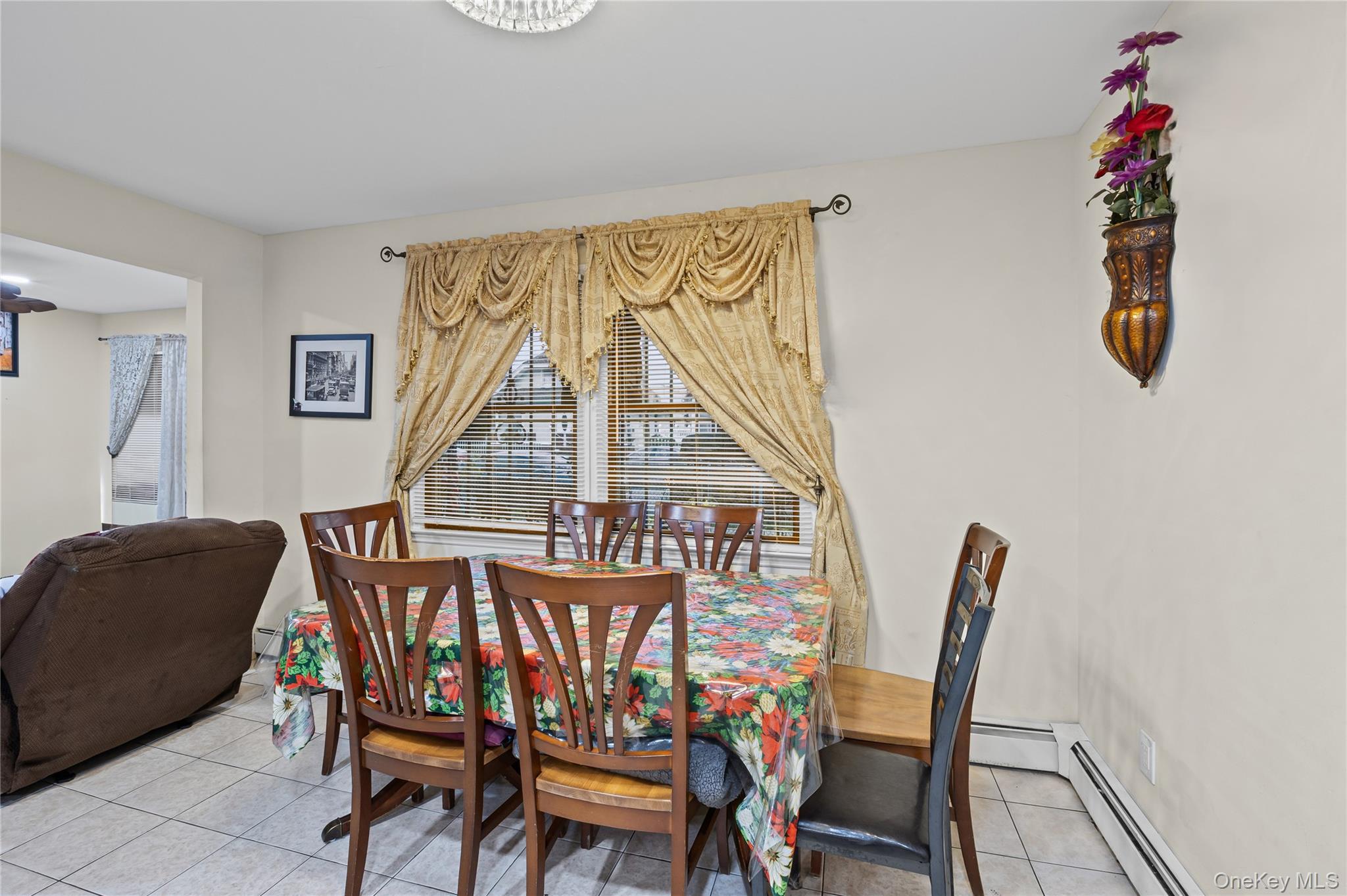 79 Union Place Hempstead, NY 11550 - Photo 8 of 26 Dining area with light tile patterned flooring and a baseboard heating unit