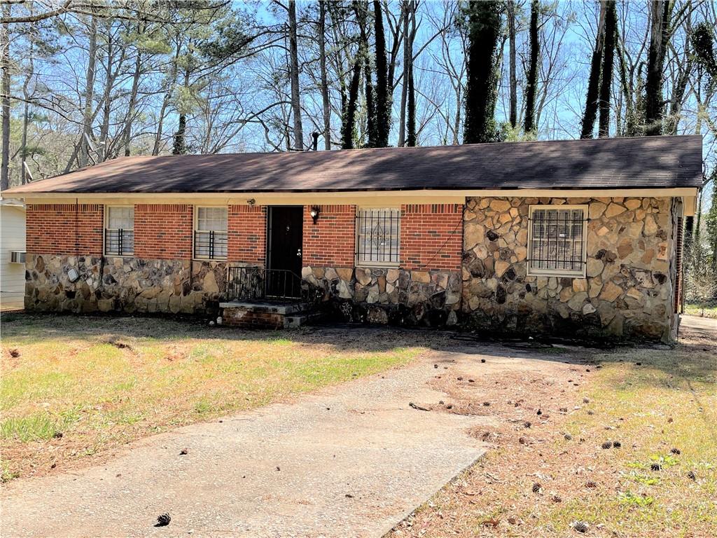 a view of a brick house with a yard