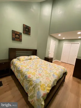 a large bed sitting in a room next to a lamp