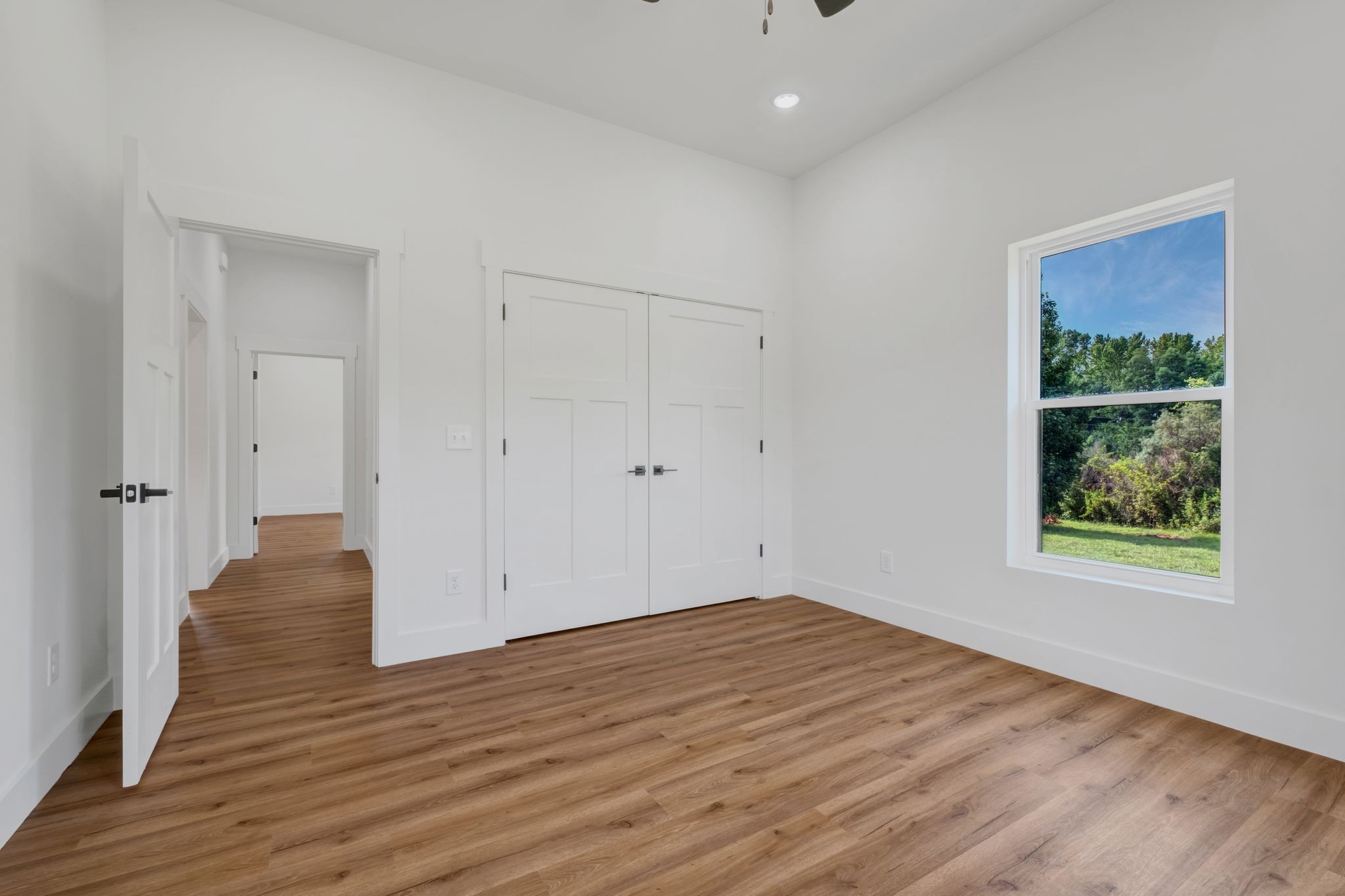 5050 Richards Road Adams, TN 37010 - Photo 26 of 52 a view of an empty room with wooden floor and a window