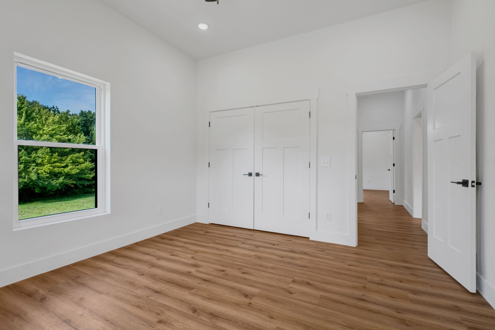 5050 Richards Road Adams, TN 37010 - Photo 30 of 52 a view of an empty room with wooden floor and a window