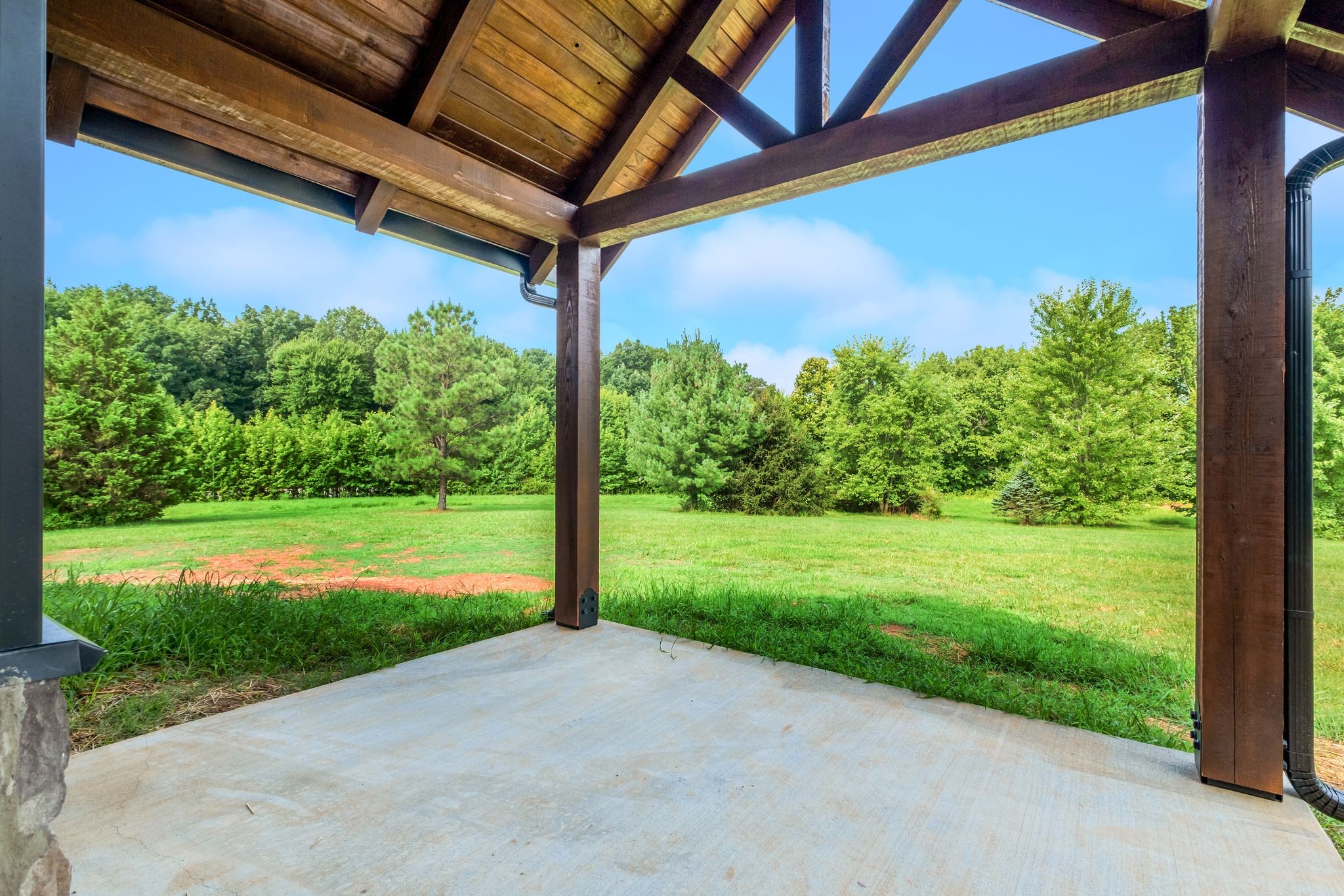 5050 Richards Road Adams, TN 37010 - Photo 32 of 52 a view of a backyard with plants and a porch