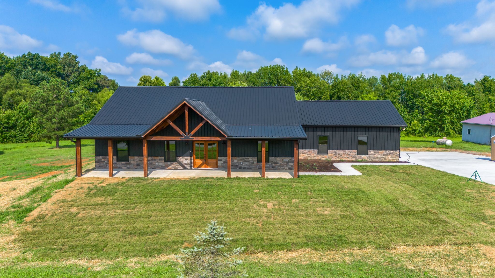 5050 Richards Road Adams, TN 37010 - Photo 34 of 52 a house that is sitting in the middle of a big yard