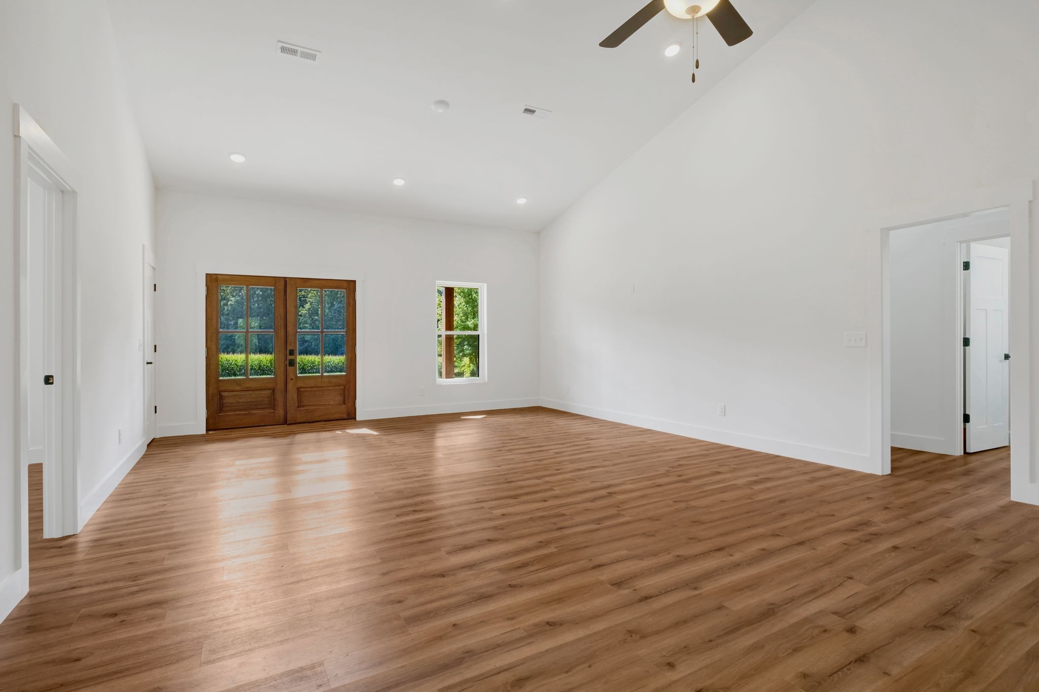 5050 Richards Road Adams, TN 37010 - Photo 9 of 52 an empty room with wooden floor and windows