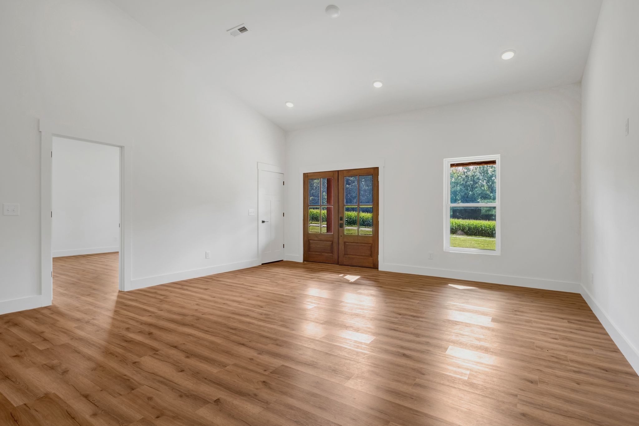 5050 Richards Road Adams, TN 37010 - Photo 10 of 52 a view of an empty room with wooden floor and a window