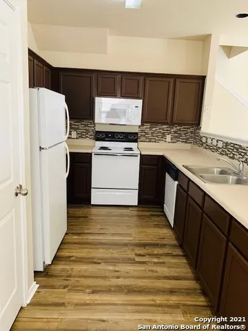 a kitchen with a sink and a refrigerator