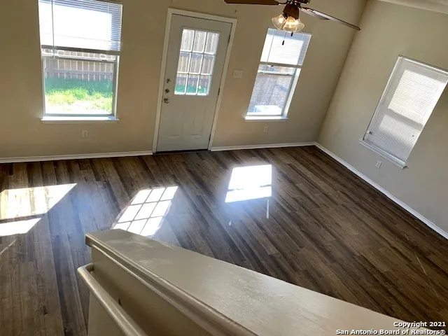 a view of an empty room and wooden floor