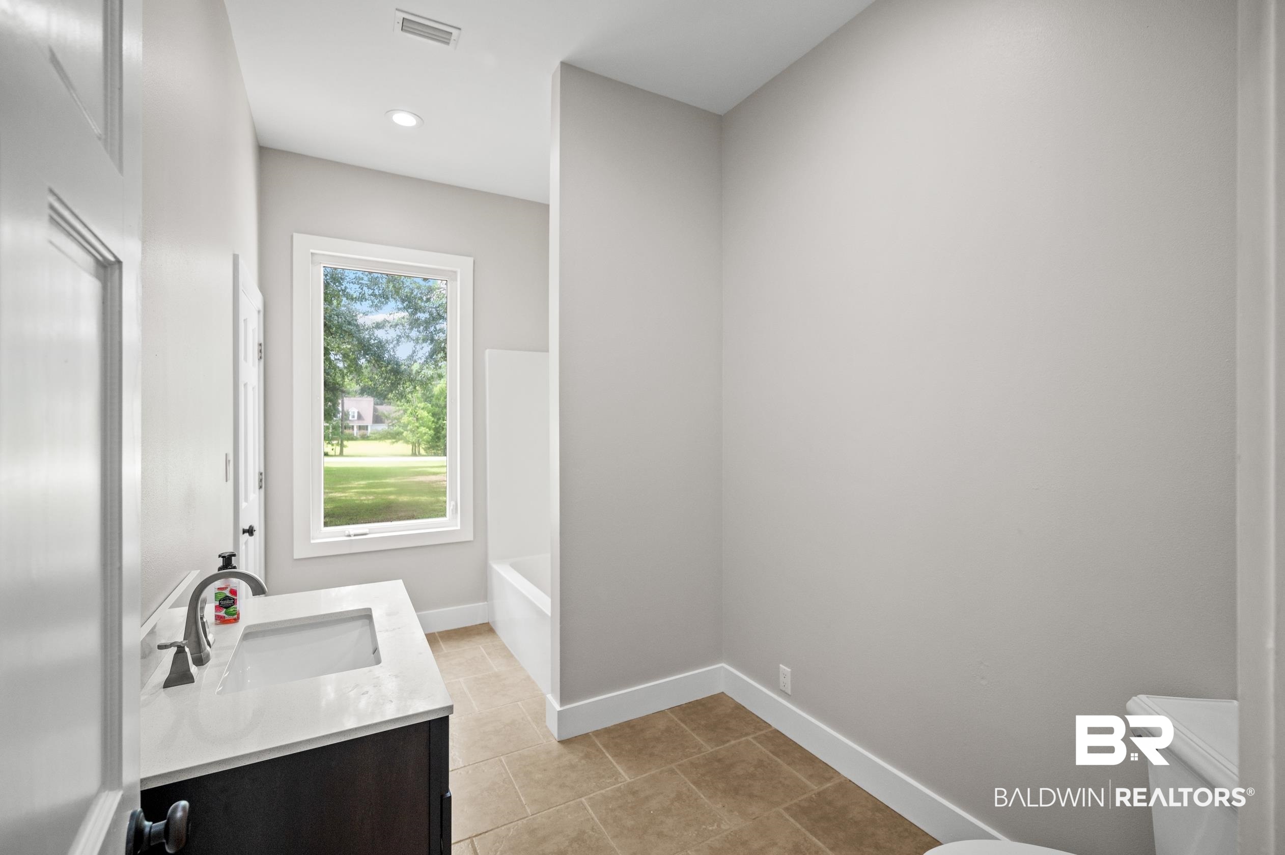 15031 Timber Ridge Drive Loxley, AL 36551 - Photo 34 of 43 Bathroom featuring tile patterned flooring, toilet, and vanity