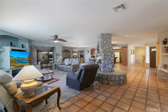 a kitchen with stainless steel appliances granite countertop a kitchen island a stove a table and chairs