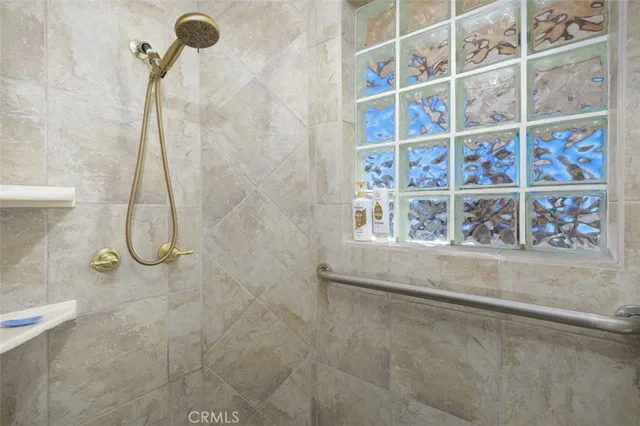 a bathroom with a granite countertop sink vanity and mirror
