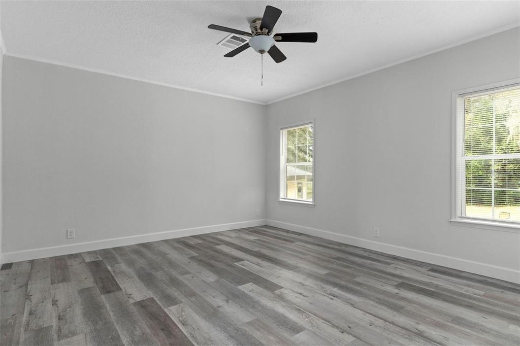 8192 Fort Dade Avenue Brooksville, FL 34601 - Photo 12 of 34 wooden floor in an empty room with a window