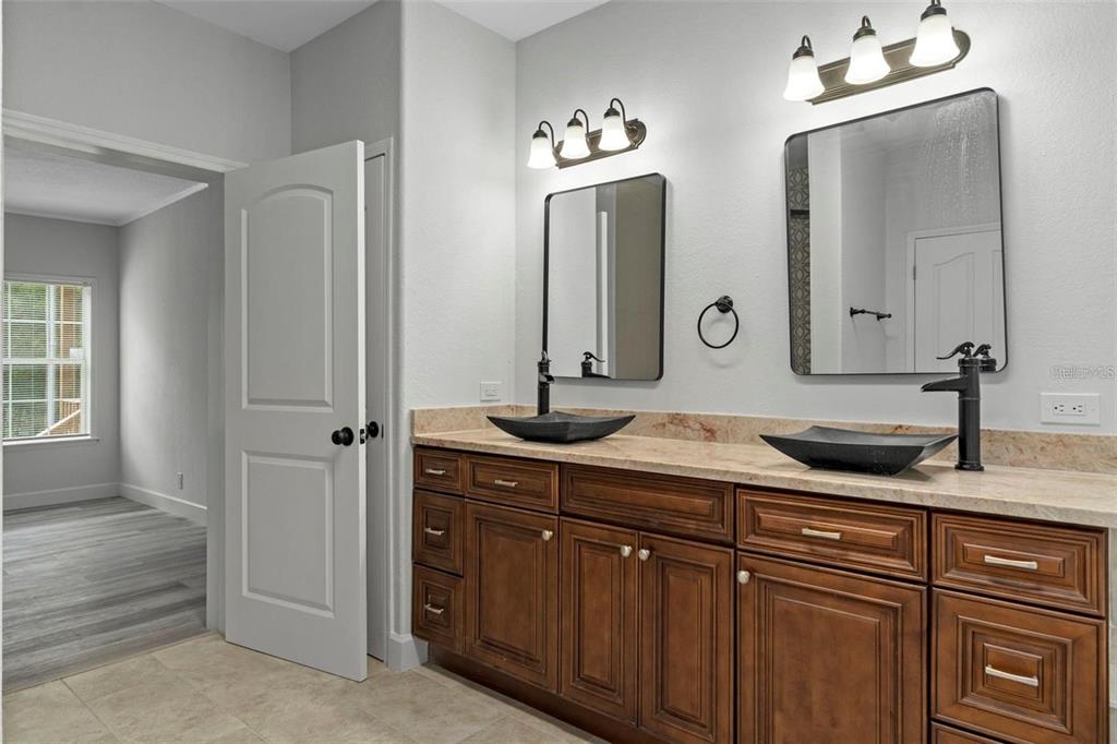 8192 Fort Dade Avenue Brooksville, FL 34601 - Photo 15 of 34 a bathroom with double vanity sinks and a mirror
