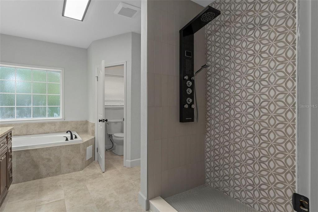 8192 Fort Dade Avenue Brooksville, FL 34601 - Photo 16 of 34 a spacious bathroom with a bathtub and a shower