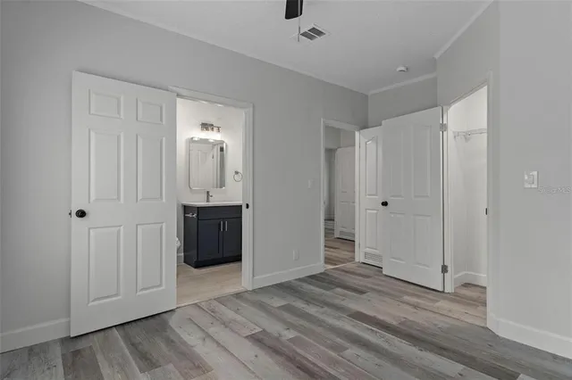 a bathroom with a granite countertop toilet a sink a mirror and shower