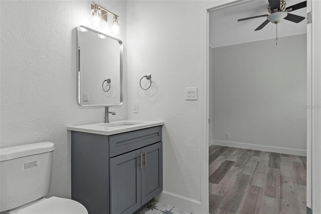8192 Fort Dade Avenue Brooksville, FL 34601 - Photo 23 of 34 a bathroom with a sink toilet and vanity