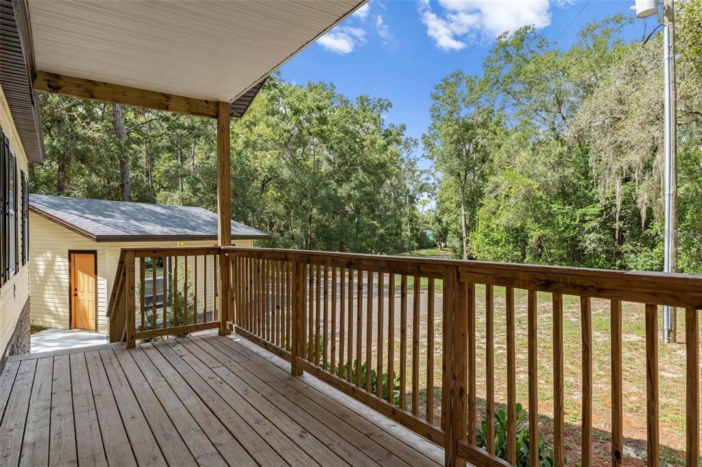 8192 Fort Dade Avenue Brooksville, FL 34601 - Photo 32 of 34 a view of balcony with wooden floor & fence