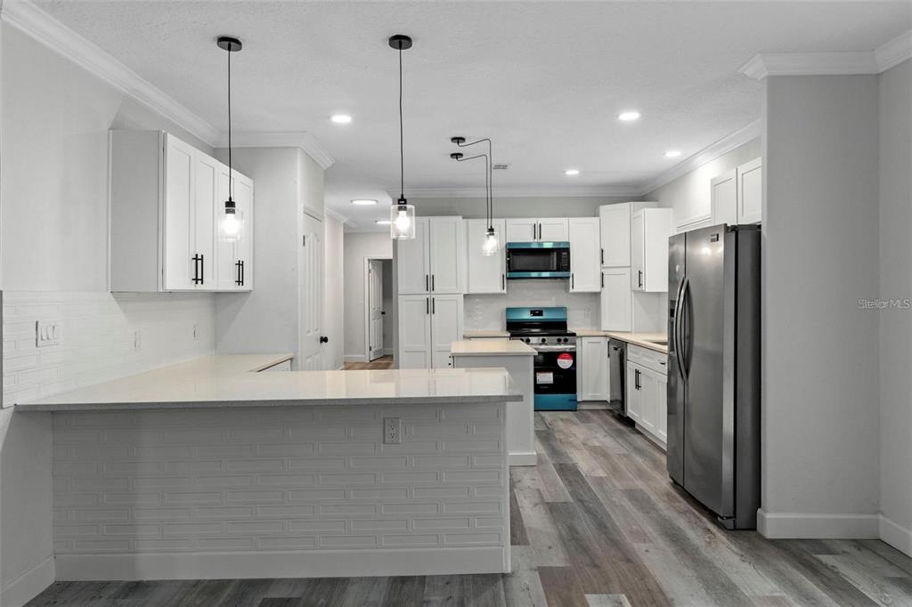 8192 Fort Dade Avenue Brooksville, FL 34601 - Photo 7 of 34 a kitchen with stainless steel appliances a refrigerator sink and microwave