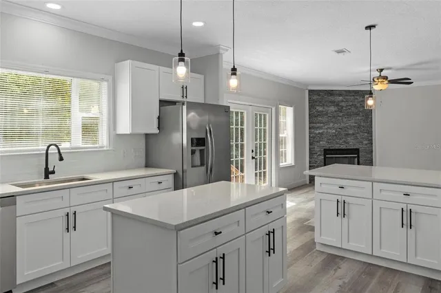 a kitchen with white cabinets and appliances