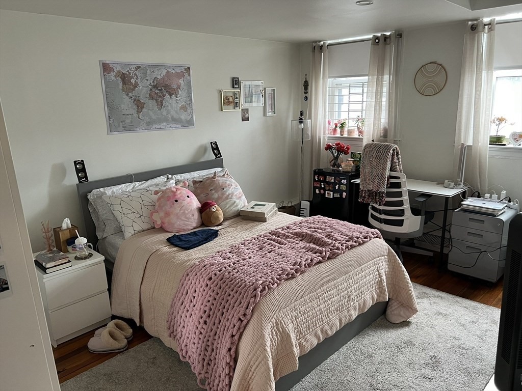 137 Peterborough Street, Unit 31 Boston, MA 02215 - Photo 7 of 14 a bedroom with a bed and wooden floor