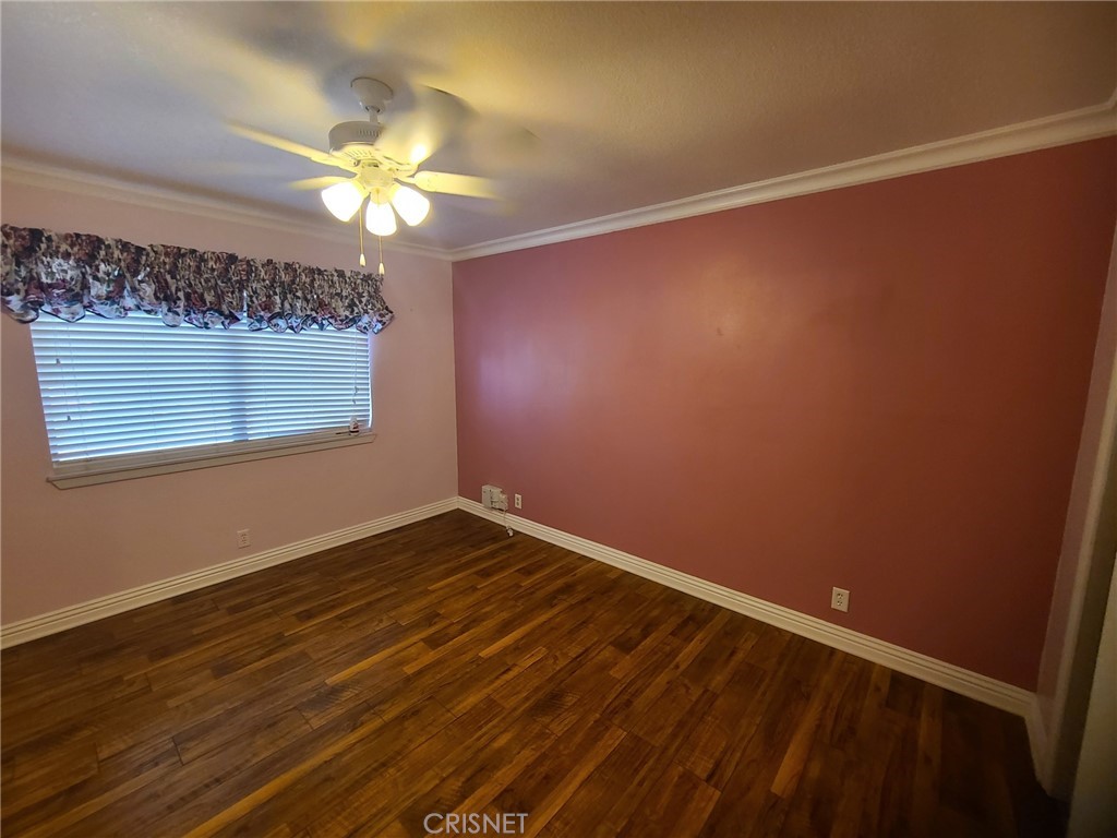 20090 Modoc Road Apple Valley, CA 92308 - Photo 12 of 23 a view of a room with wooden floor and a ceiling fan