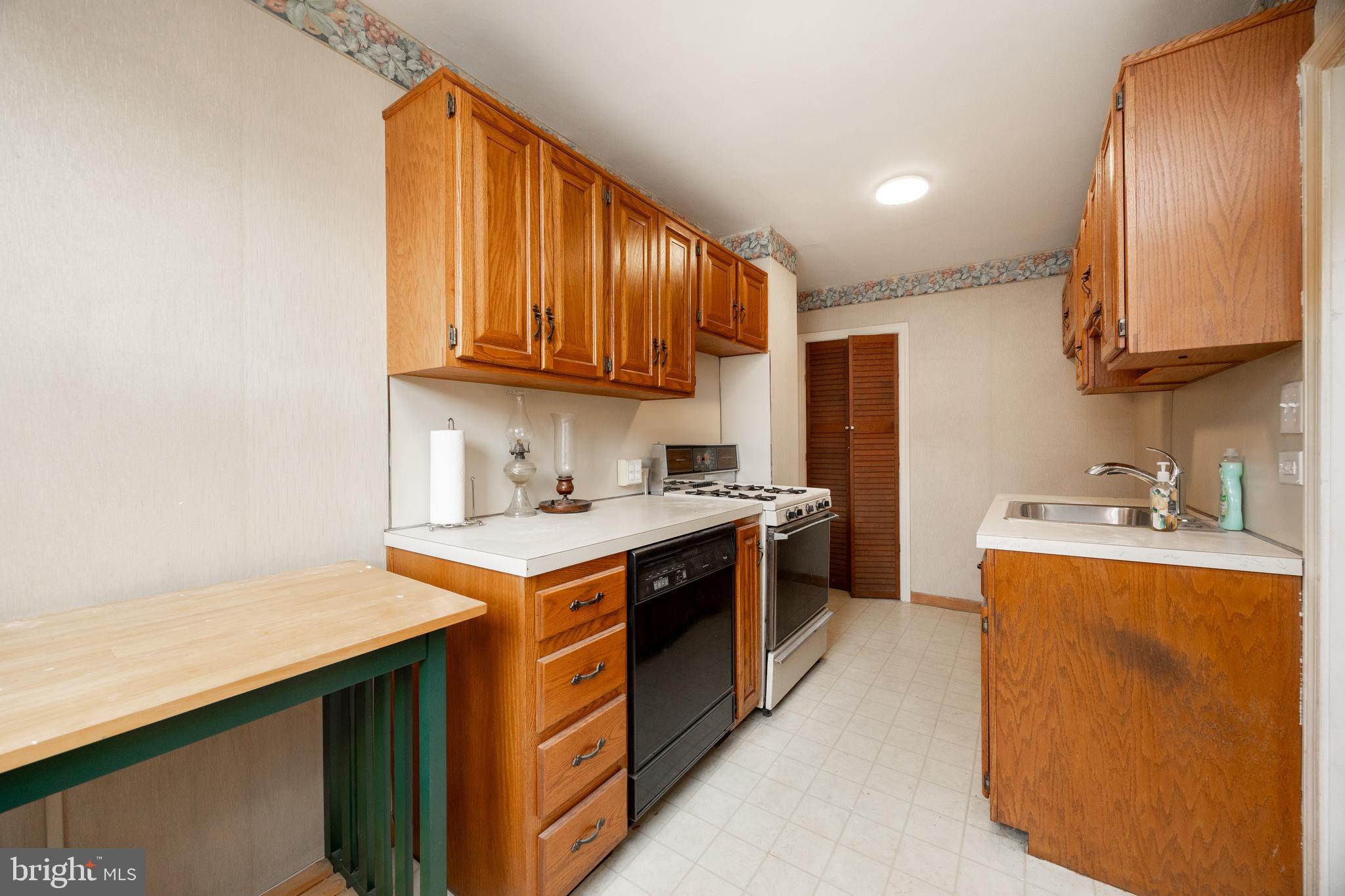 3128 Disston Street Philadelphia, PA 19149 - Photo 11 of 20 a kitchen with stainless steel appliances granite countertop a stove a sink and a refrigerator