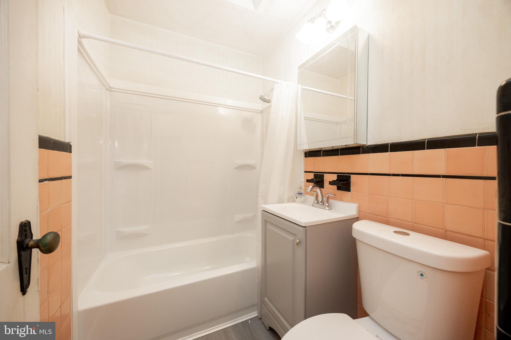 3128 Disston Street Philadelphia, PA 19149 - Photo 16 of 20 a bathroom with a sink a toilet and shower