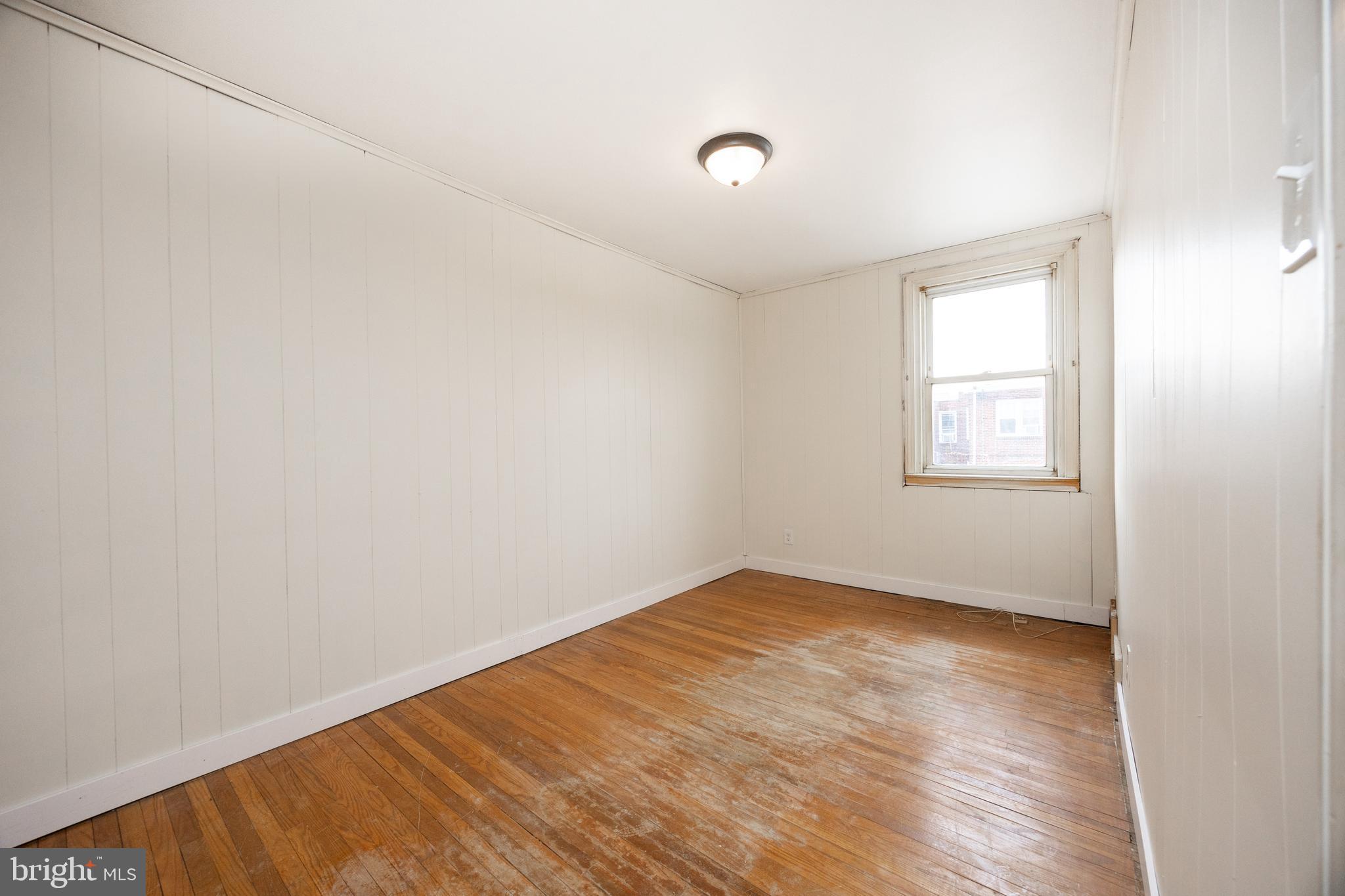 3128 Disston Street Philadelphia, PA 19149 - Photo 17 of 20 an empty room with wooden floor and windows