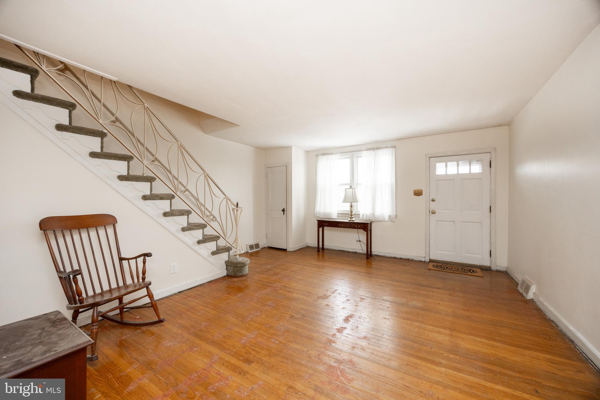 3128 Disston Street Philadelphia, PA 19149 - Photo 4 of 20 a view of an empty room with stairs and a workspace
