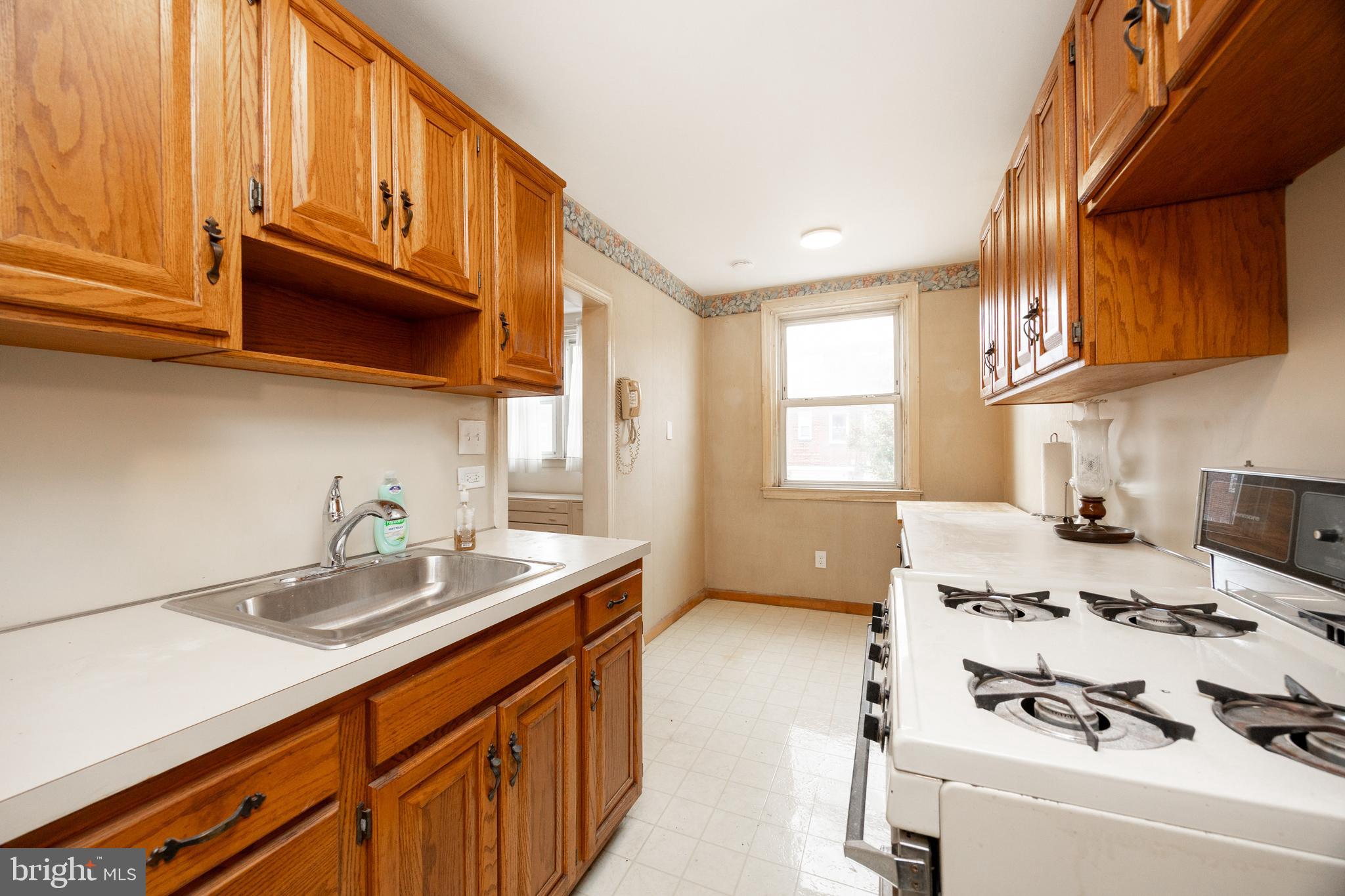 3128 Disston Street Philadelphia, PA 19149 - Photo 9 of 20 a kitchen with a sink a stove and cabinets