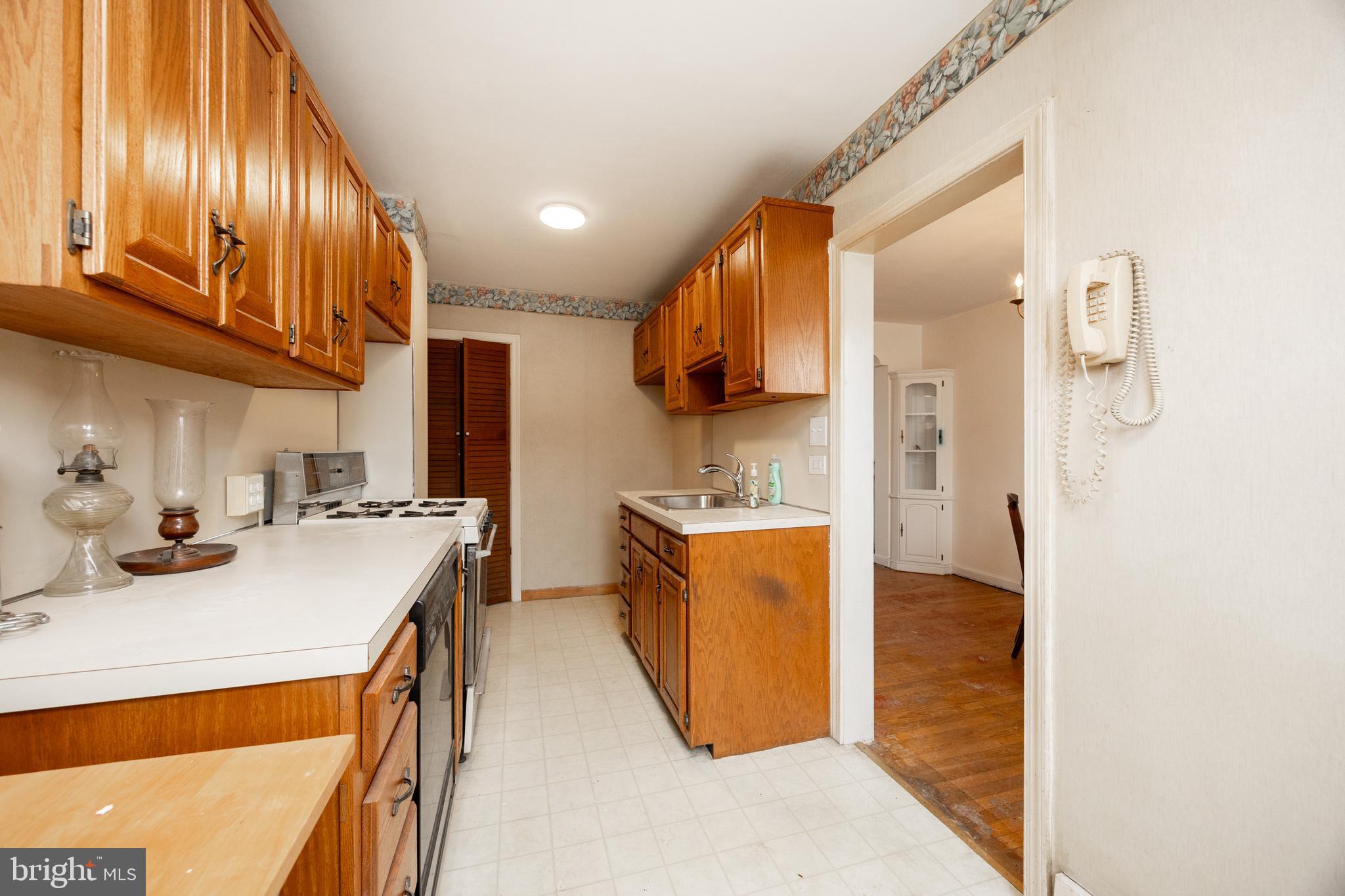 3128 Disston Street Philadelphia, PA 19149 - Photo 10 of 20 a kitchen with stainless steel appliances a sink stove and refrigerator