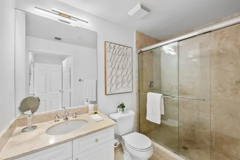 a bathroom with a sink toilet and shower