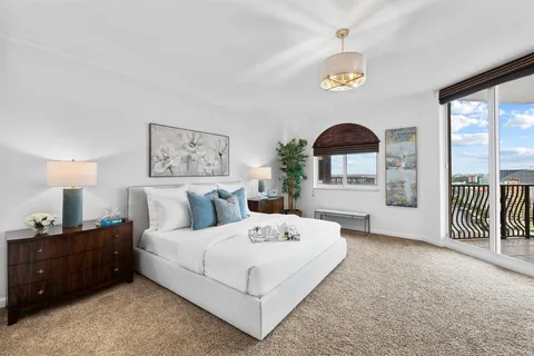 a bedroom with a large bed and a window