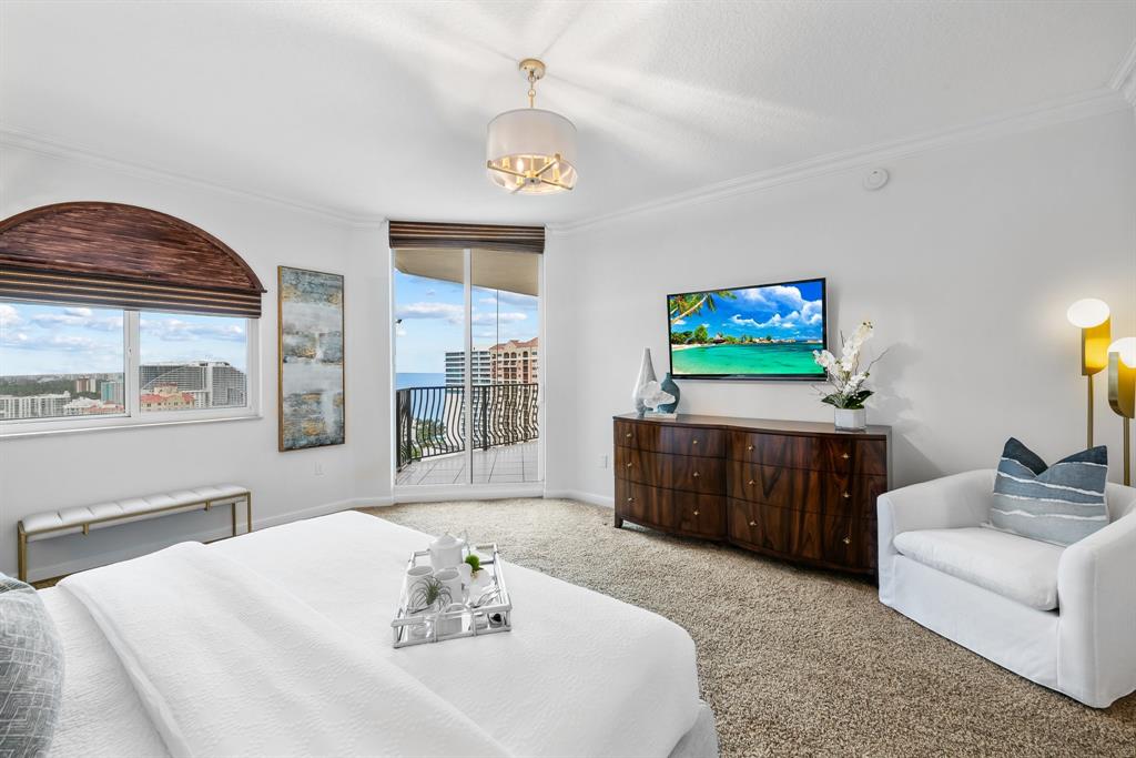 100 South Birch Road, Unit 2403 Fort Lauderdale, FL 33316 - Photo 19 of 26 a living room with furniture a flat screen tv and a chandelier