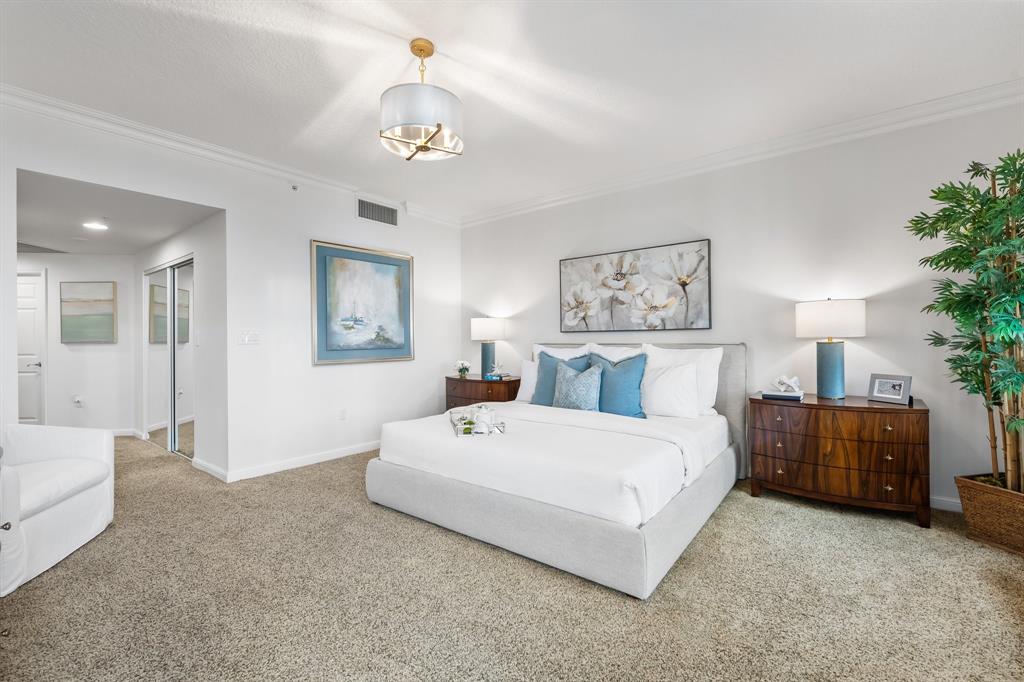 100 South Birch Road, Unit 2403 Fort Lauderdale, FL 33316 - Photo 20 of 26 a bedroom with a large bed and a chandelier