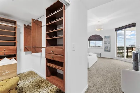 a view of walk in closet and bedroom view