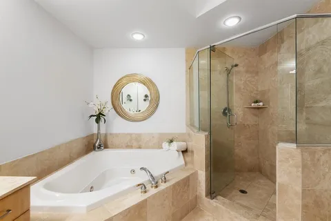 a bathroom with a tub and a shower
