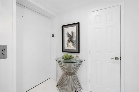 a view of a room with wall cabinet and window