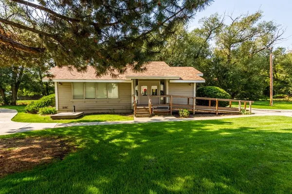 a front view of a house with a yard table and chairs