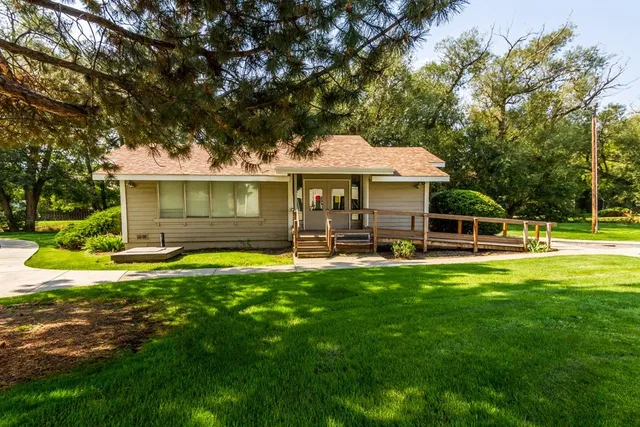 a front view of a house with a yard table and chairs