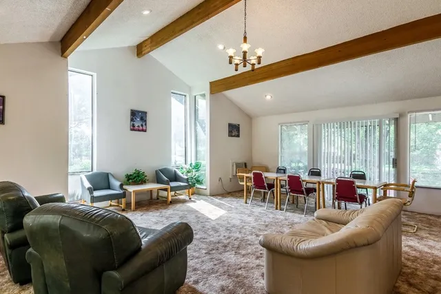 a living room with furniture and chandelier