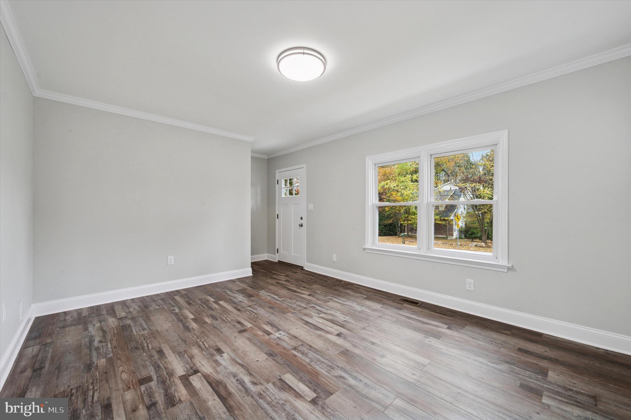 1721 Naamans Creek Road Upper Chichester, PA 19061 - Photo 12 of 33 an empty room with wooden floor and windows