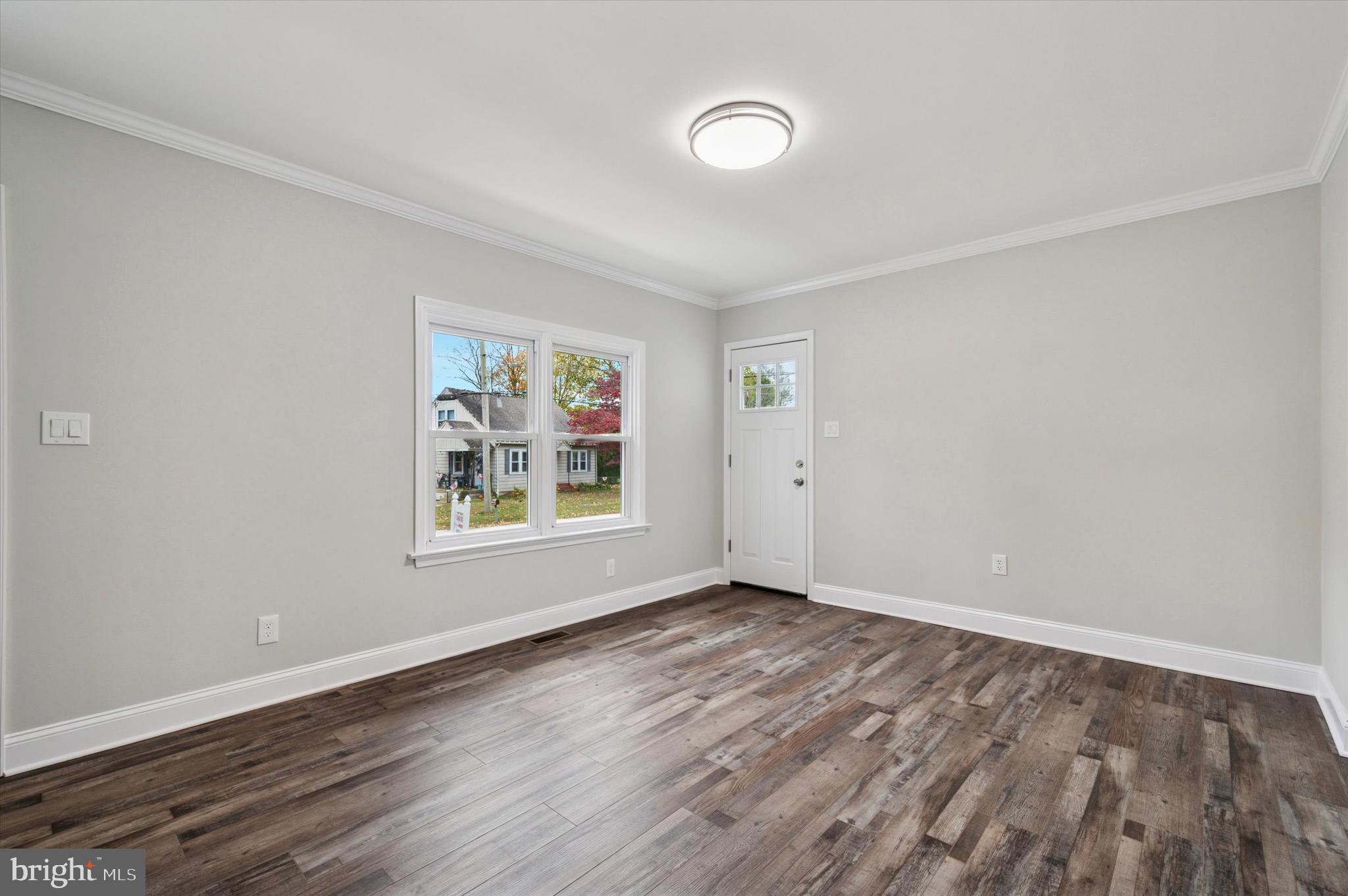 1721 Naamans Creek Road Upper Chichester, PA 19061 - Photo 13 of 33 a view of an empty room with wooden floor and a window