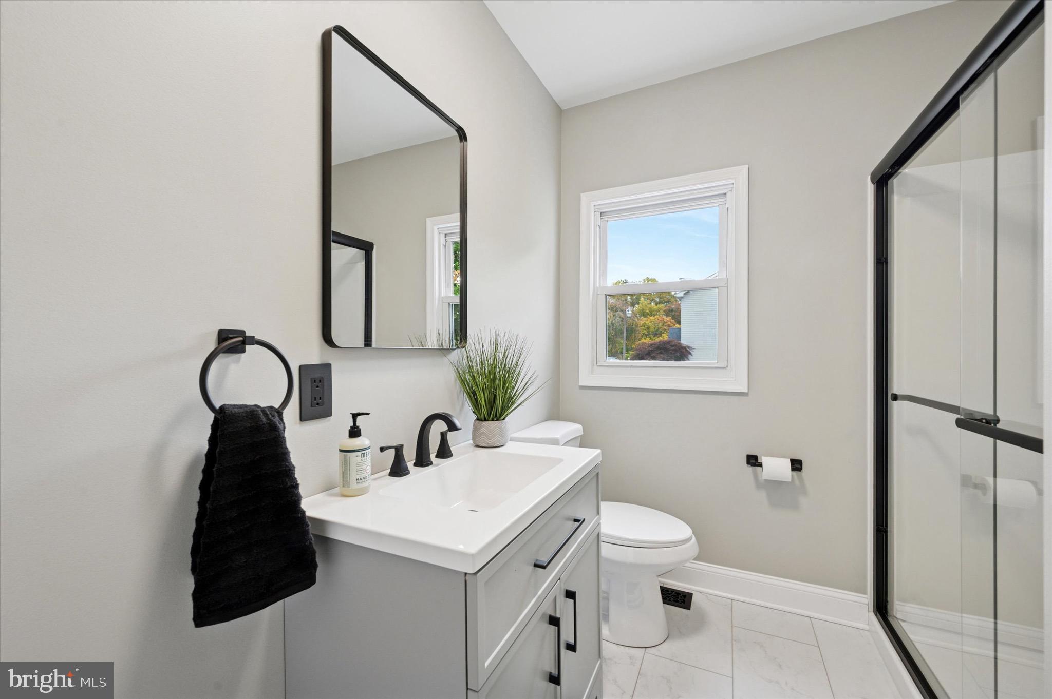 1721 Naamans Creek Road Upper Chichester, PA 19061 - Photo 14 of 33 a bathroom with a toilet sink and mirror
