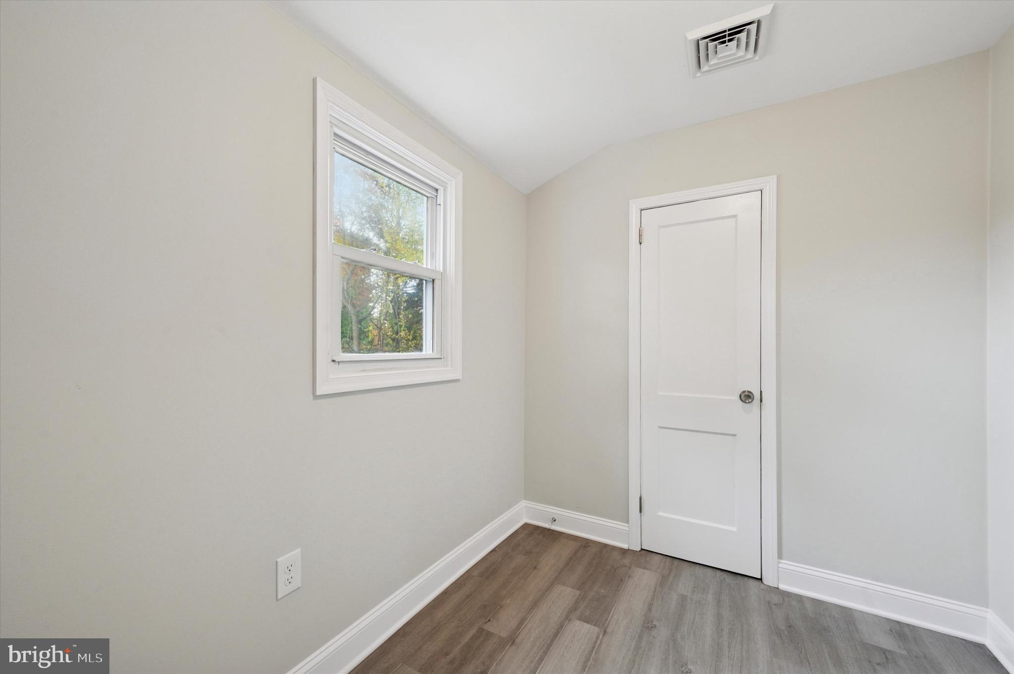 1721 Naamans Creek Road Upper Chichester, PA 19061 - Photo 21 of 33 a view of an empty room with wooden floor and a window