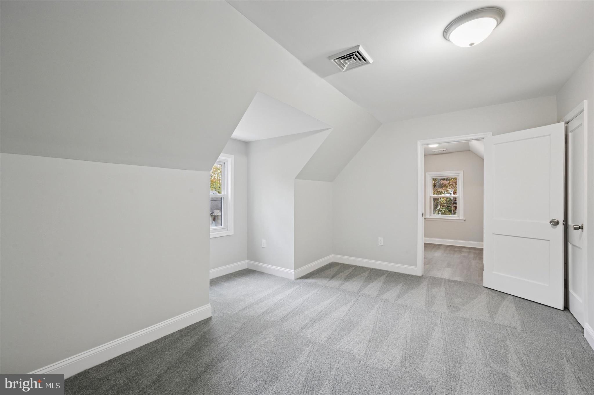 1721 Naamans Creek Road Upper Chichester, PA 19061 - Photo 24 of 33 an empty room with wooden floor and windows