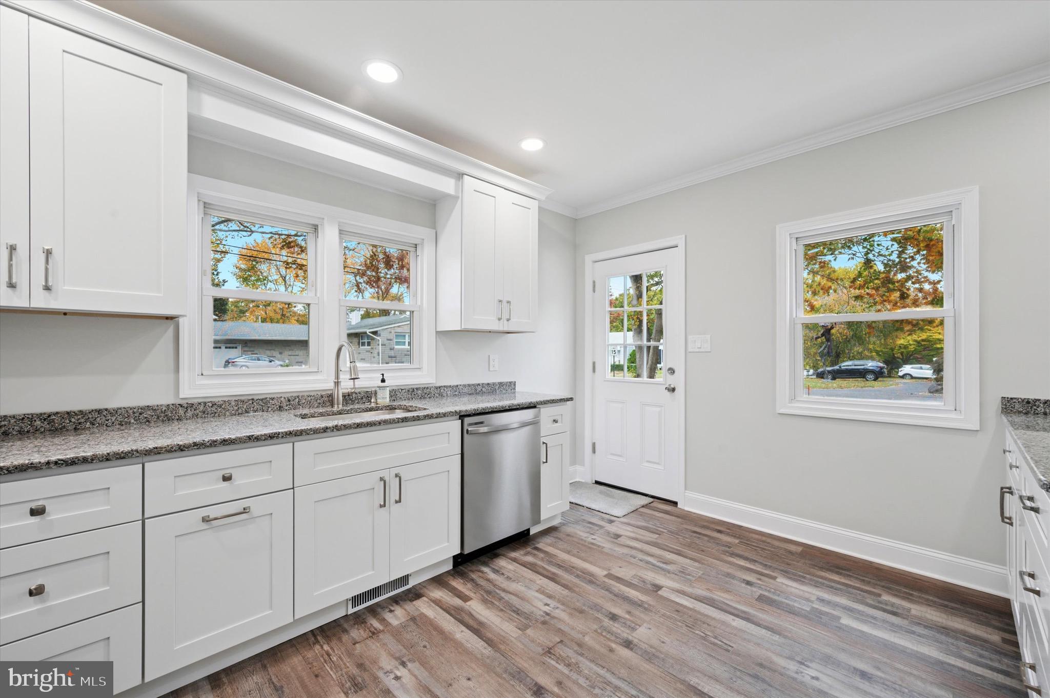 1721 Naamans Creek Road Upper Chichester, PA 19061 - Photo 5 of 33 a kitchen with granite countertop white cabinets and window