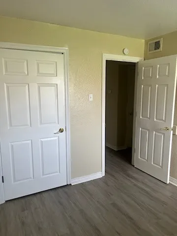 a view of an entryway with wooden floor