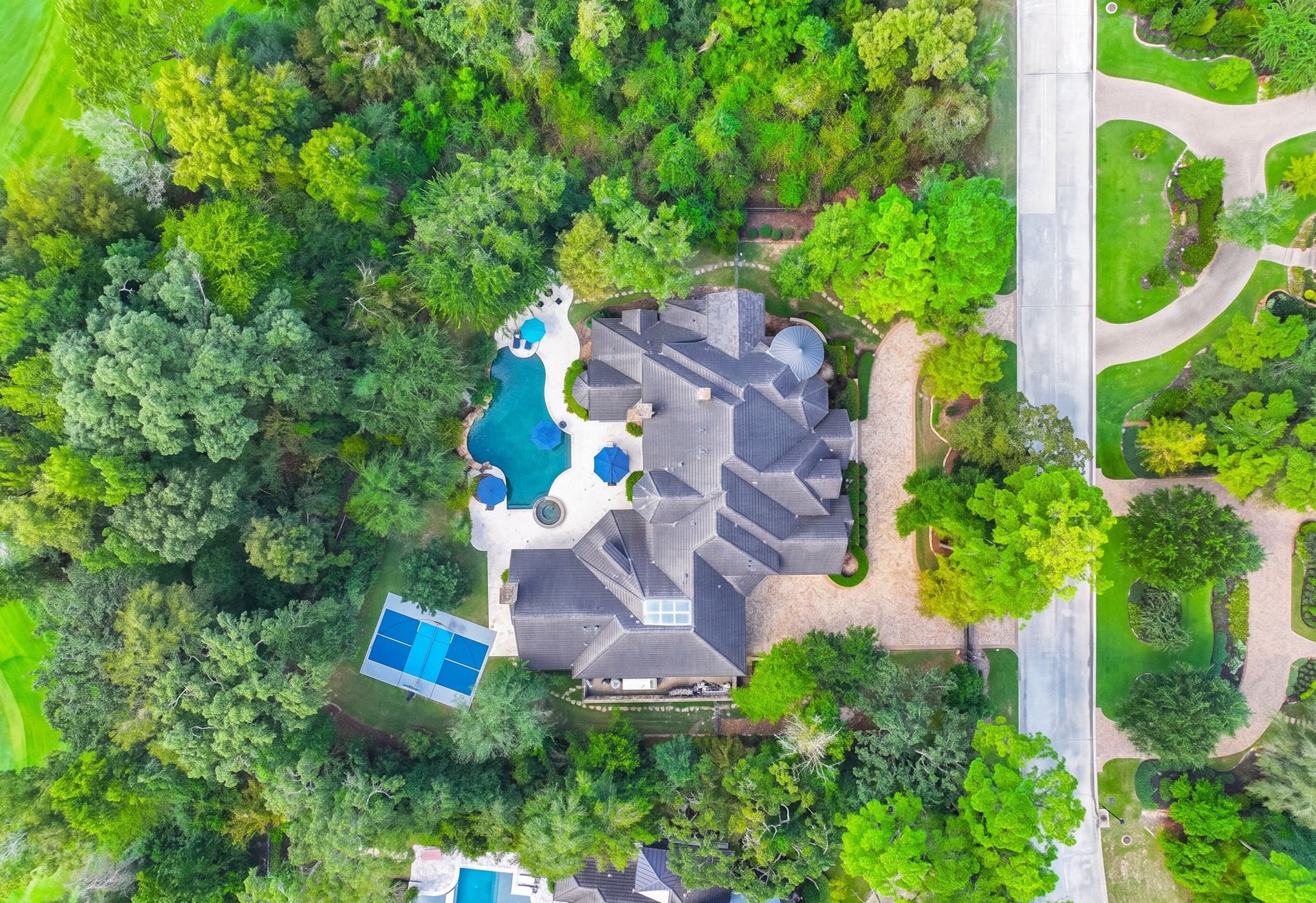 247 S. Fazio Way offers a true resort-style living experience with a sparkling pool, sports court, expansive outdoor living spaces, and unmatched privacy in the heart of Carlton Woods.