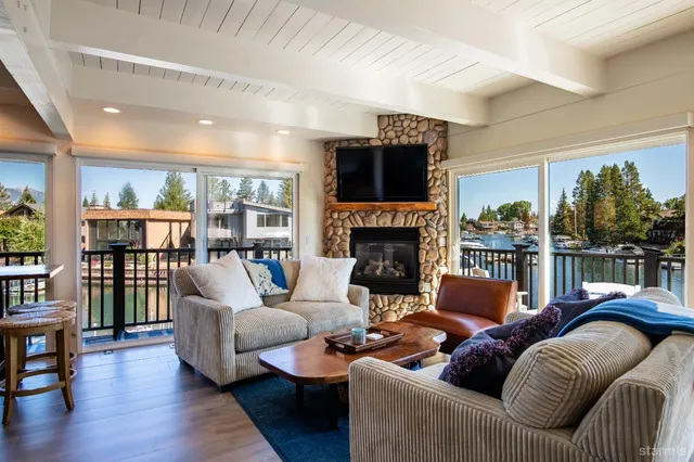 a living room with furniture fireplace and a large window